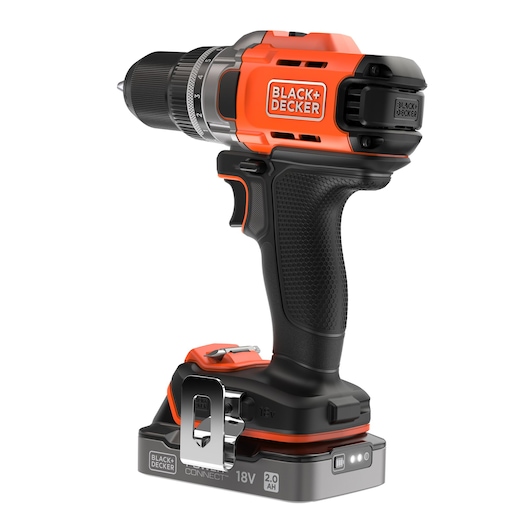 A BLACK+DECKER cordless power drill with an 18V 2.0Ah battery, featuring a black and orange ergonomic design, and a metal belt clip on the base.
