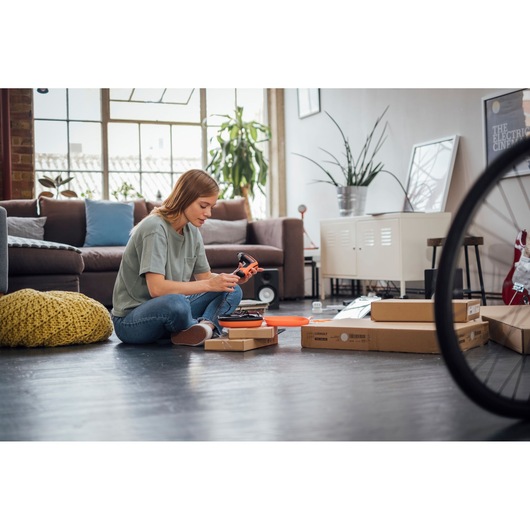 BLACKDECKER BCF611CK cordless screwdriver used for assembly in a modern living room setting.