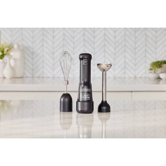 Photo of BLACK+DECKER BCKM1012KB hand mixer set with whisk and blending attachments on a kitchen counter.