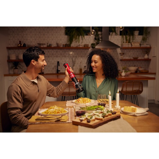 BLACKDECKER BCKM1012KR cordless kitchen tool used at a dinner table with pasta and candles.
