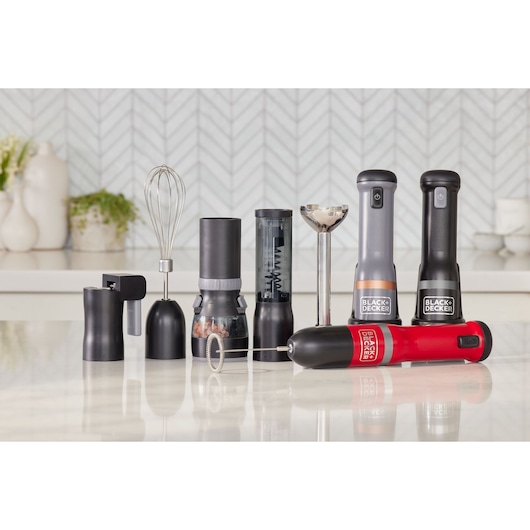 Photo of BLACK+DECKER BCKM1012KR kitchen appliance set with multiple black and red hand mixers and attachments on counter.