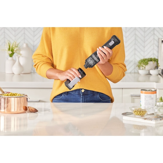 Photo of BLACKDECKER BCKM1016KSB kitchen tool held by person in yellow sweater in modern kitchen.