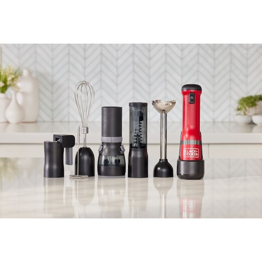 BLACK+DECKER BCKM1016KSR red and black hand blender set with multiple attachments on a kitchen counter, front view.