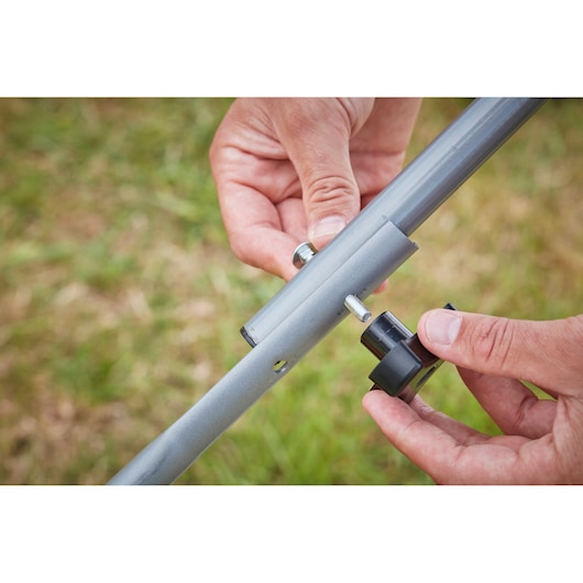 BLACKDECKER BCMW3336L2 lawn mower handle assembly with bolt and knob, outdoor close-up.