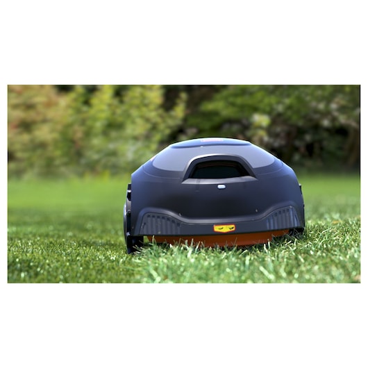 BLACKDECKER BCRMW122 robotic lawn mower rear view on grass outdoors.