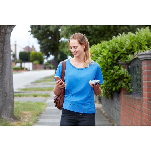 BLACKDECKER BDCB12B portable device and charger held by person on sidewalk, casual outdoor setting.