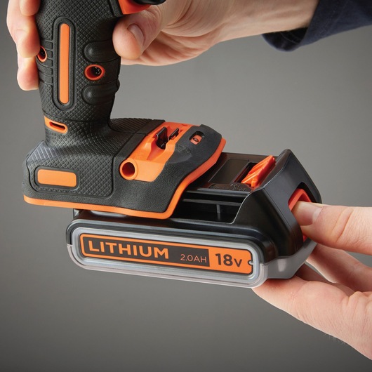 BLACKDECKER BDCHD18K1B2 cordless drill close-up with 18V 2.0Ah lithium battery being attached.