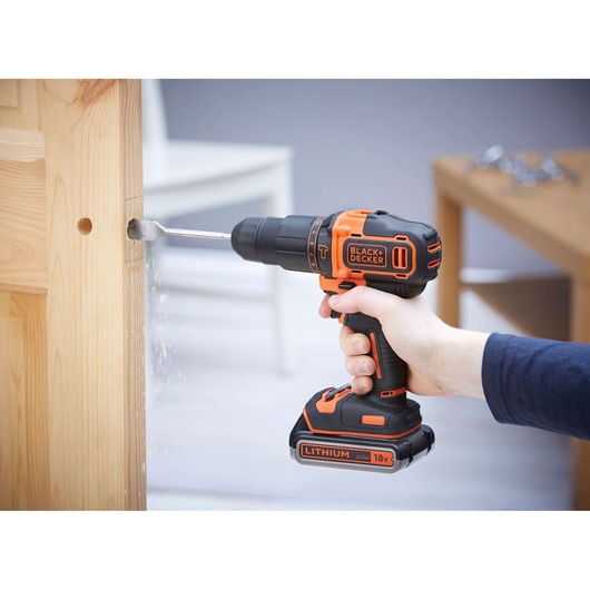 Photo of BLACKDECKER BDCHD18KB2 cordless drill in use on a wooden door.