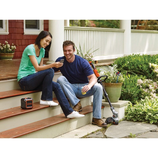 Photo of BLACKDECKER BDCSP18N portable power station and cordless string trimmer on porch steps.