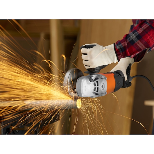 BLACKDECKER BDGL2223 angle grinder in use, cutting metal pipe, producing sparks, close-up view.