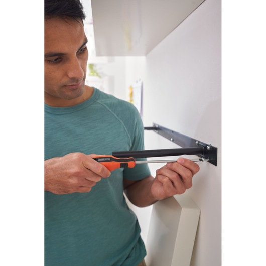 Photo of BLACKDECKER BDHT84014 screwdriver in use assembling furniture against wall.