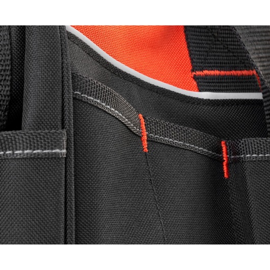 Close-up of BLACKDECKER BDST83002 tool bag pocket stitching with black fabric and red accents.