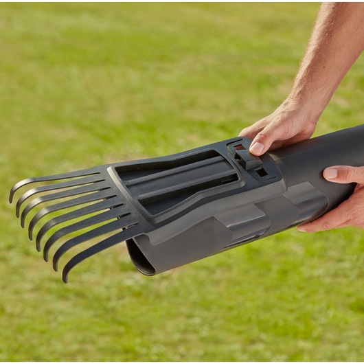 BLACKDECKER BEBLV301 leaf blower accessory with black rake attachment held outdoors.
