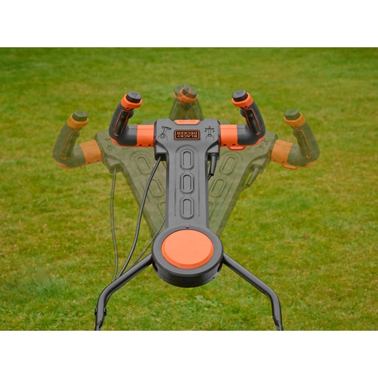 BLACKDECKER BEMW471ES lawn mower adjustable handle in grass, top angle photo.