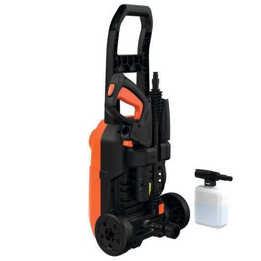A BLACK+DECKER portable pressure washer in black and orange with a handle, wheels, and a spray gun attached to the unit. Next to it is a separate soap dispenser attachment.