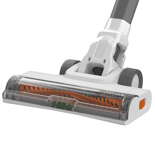Close-up of a vacuum cleaner floor head attachment with a transparent cover revealing an orange and black rotating brush, featuring wheels and part of the handle.