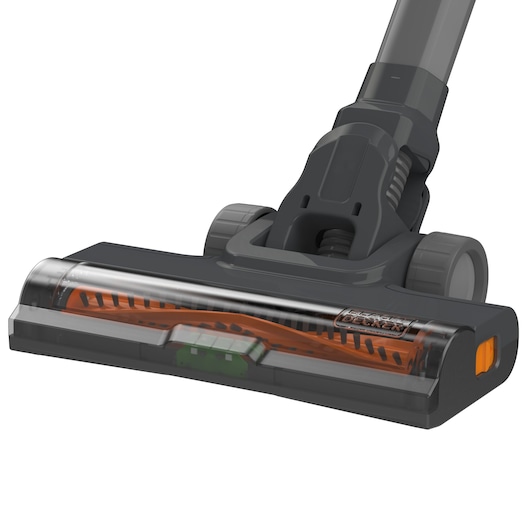 Close-up image of the floor cleaning head of a BLACK+DECKER cordless vacuum cleaner, featuring a transparent cover and visible orange brush roller.