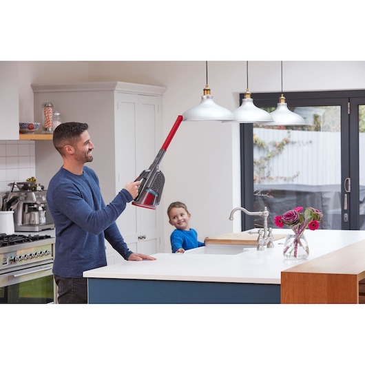 BLACKDECKER BHHV315B handheld vacuum cleaning pendant lights in a modern kitchen.