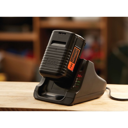 BLACKDECKER BL20362 battery charger with 36V lithium-ion battery on wooden table, photography side view.