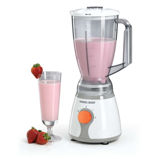 A BLACK+DECKER blender filled with pink strawberry smoothie, next to a glass of the same smoothie garnished with a strawberry and surrounded by fresh strawberries.