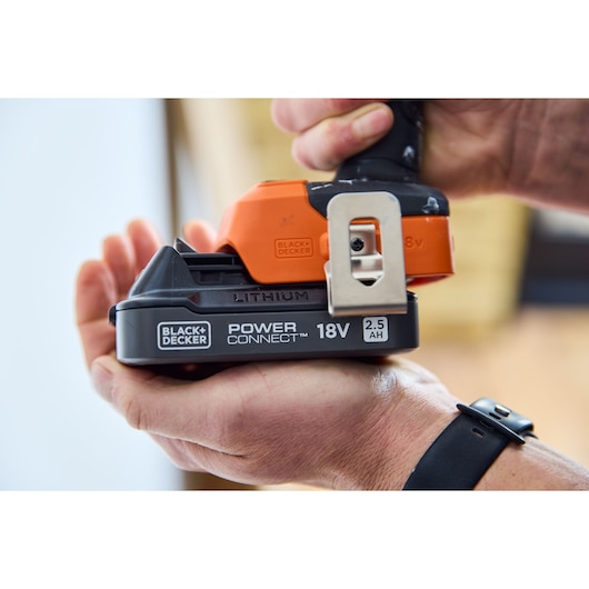 Close-up photo of BLACK+DECKER BLIM78E1K lithium 18V 2.5Ah Power Connect battery pack being held in a hand.