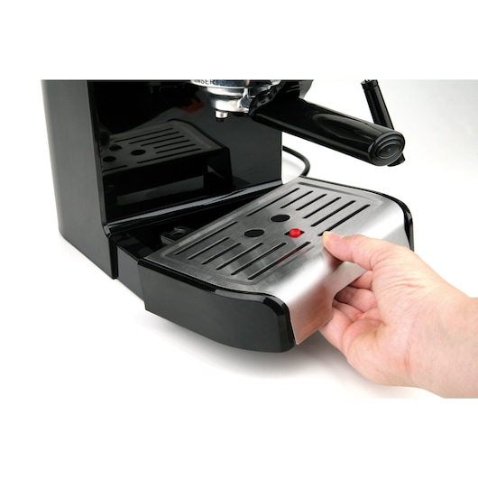 BLACKDECKER BXCO1200E espresso machine with hand removing stainless steel drip tray, front angle.