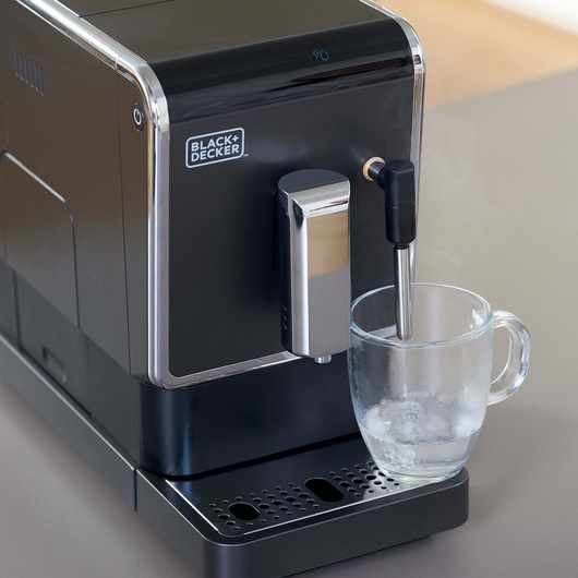 Photo of BLACK+DECKER coffee machine BXCO1470E with glass cup on steam wand, front angle.
