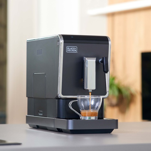 BLACK+DECKER BXCO1470E coffee machine brewing espresso in glass cup, kitchen background.