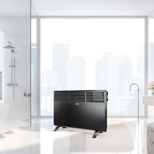 BLACKDECKER BXCSH1200E black panel heater in modern bathroom setting, angled front view.