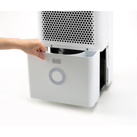 BLACK+DECKER BXDH12E dehumidifier front view, hand removing water tank, white color.