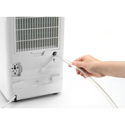 Photo of BLACKDECKER BXDH12E dehumidifier rear view with hand connecting drainage hose.
