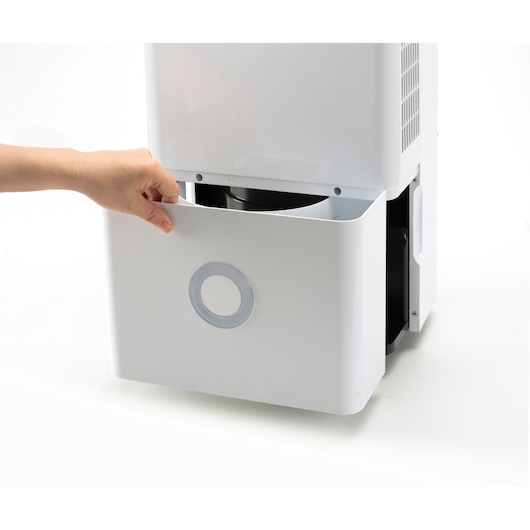 BLACKDECKER BXDH20E dehumidifier with visible water tank, hand pulling out tank, front angle on white background.