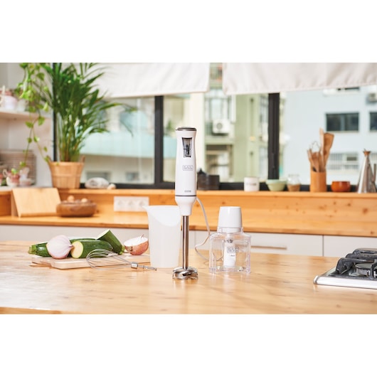 BLACKDECKER BXHBA600E hand blender set with accessories on kitchen counter, vegetables beside.