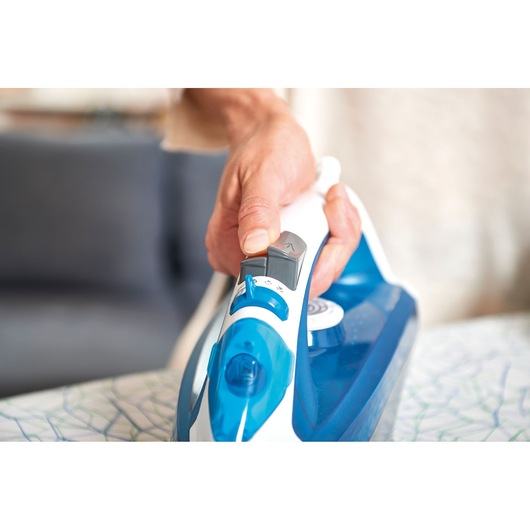 BLACKDECKER BXIR2200E steam iron in blue and white held in hand, close-up with visible controls.