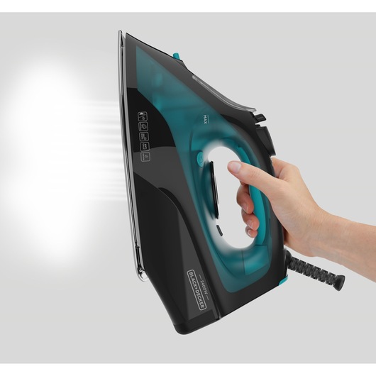 BLACK+DECKER BXIR2403E steam iron side angle, black and teal, shown in hand, emitting steam.