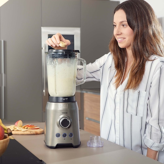 BLACKDECKER BXJB1200E blender in use on kitchen counter with smoothie mixture in glass jar.