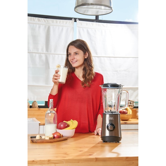 BLACKDECKER BXJB800E blender on a kitchen counter with fruit, milk, and smoothie glass.