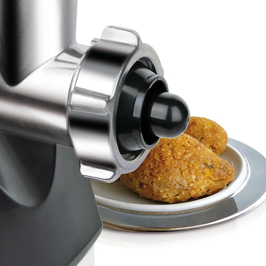 BLACKDECKER BXMMA1000E electric meat grinder close-up with metal and black finish, food plate with kibbeh in background, side angle.