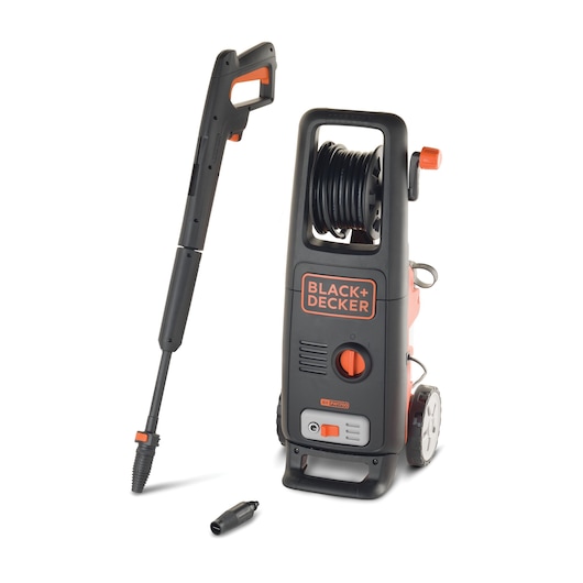 A BLACK+DECKER BXPW1700E pressure washer is shown with its spray gun and hose attachment. The machine is black and orange, has a carrying handle, wheels, a hose reel at the top, and branding on the front. An additional nozzle is placed in front of the washer.