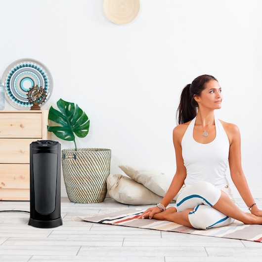 BLACKDECKER BXSH2002E ceramic tower heater near yoga mat in modern room.