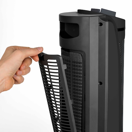 BLACKDECKER BXSH2002E tower fan with a hand removing the front grille to access the filter, white background.