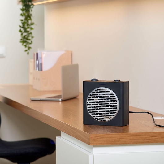 BLACKDECKER BXSH2003E portable heater with grill front on desk in modern office setting.