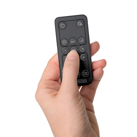 BLACKDECKER BXWSH2000E remote control held in a hand, close-up, white background.