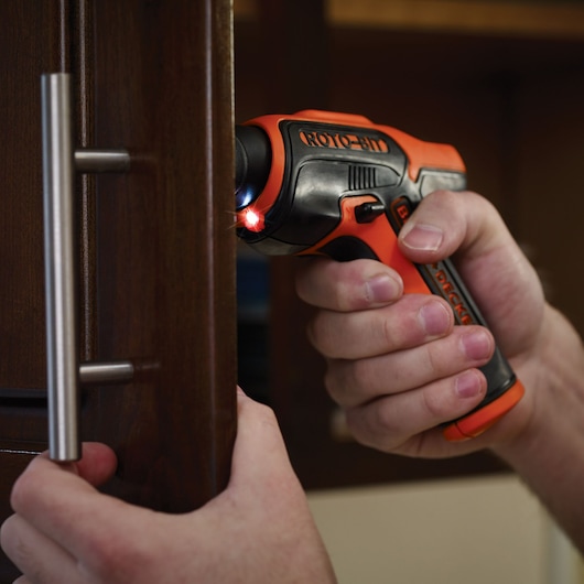 BLACKDECKER CS36BSCES cordless screwdriver used on a cabinet, close-up photography