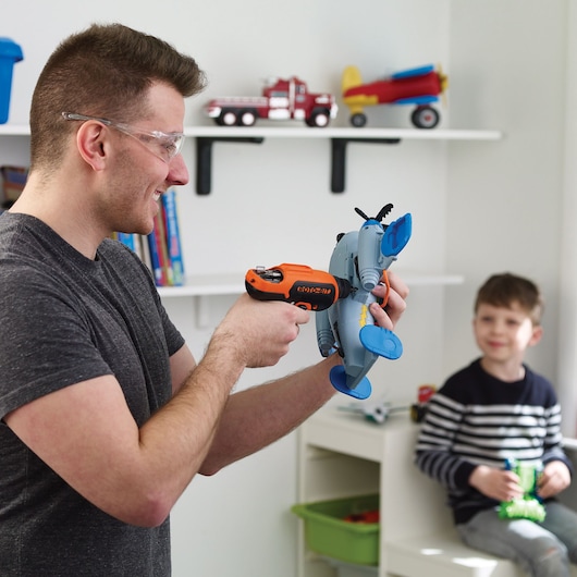 Photo of BLACKDECKER CS36BSCES cordless screwdriver held while assembling a toy airplane indoors.