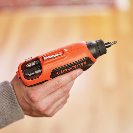 BLACKDECKER CS36BSCES cordless screwdriver with built-in bit storage held in hand, orange and black design.