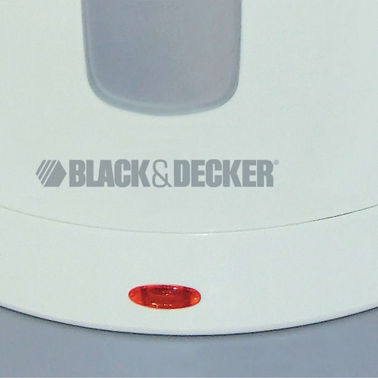 Close-up of a white device with the BLACK+DECKER logo printed on it, showing a red indicator light near the base.