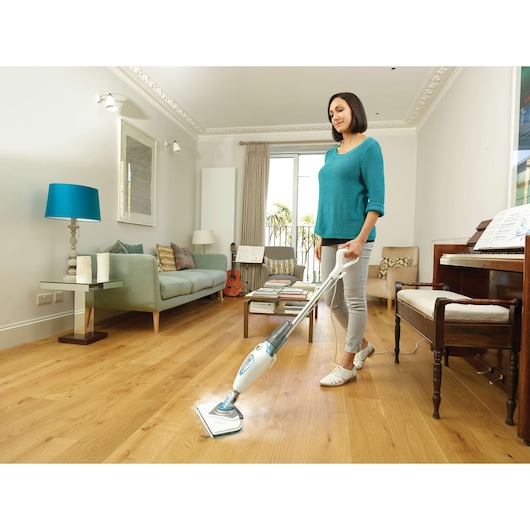 BLACKDECKER FSM1616 steam mop cleaning hardwood floor in a modern living room setting.