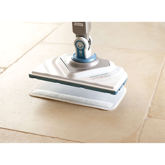 BLACKDECKER FSM1616 steam mop with white and blue head cleaning tile floor, side angle photo.
