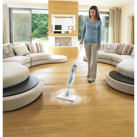 BLACKDECKER FSM1630 steam mop cleaning wood floor in modern living room.